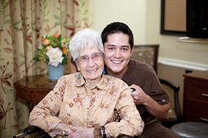A nurse smiling with an elderly woman