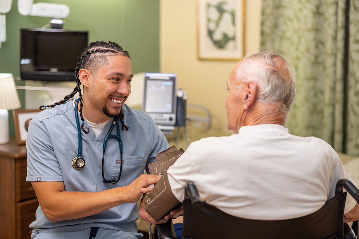 Nurse taking blood pressure at Rock Creek Care Center